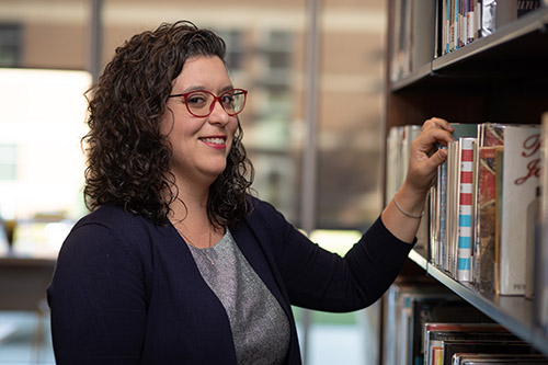 Jenna Caviezel looks through books at the Motlow State Community College library. Professor Caviezel is the Director of Motlow’s Writing Center, which recently hosted the state’s annual Tutor Collaboration Day Conference, a first for a community college.