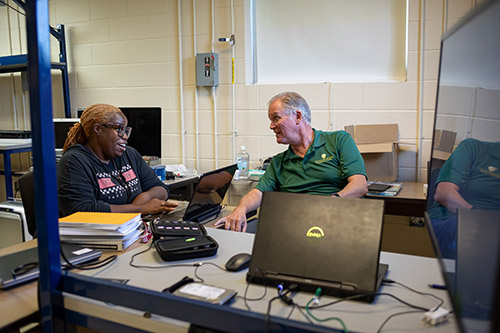 Motlow student Janesia Harlston, left, talks to Walter McCord, head of PLA and a Cyber Defense instructor at Motlow. Harlston was able to earn credit for two courses after completing some Google IT Support certifications.